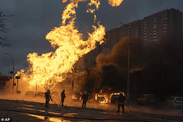 Firefighters work to extinguish a fire after a Russian attack in Kiev, Ukraine