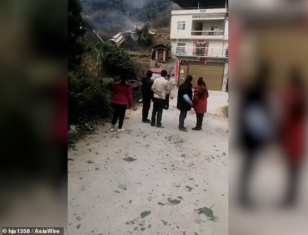 When debris crashed into a village in Baise, Guangxi (pictured) petrified villagers gathered near the site, believing it was a UFO.