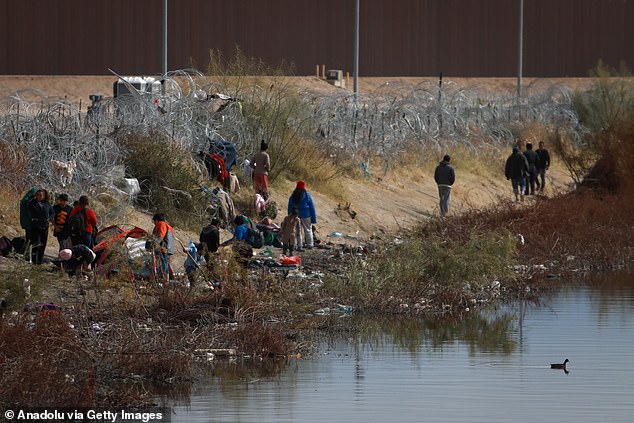 Migrants set up camp in the Rio Bravo, waiting to enter American Gate 36 as U.S. soldiers cut off all access to the barbed wire fence in Ciudad Juarez, Mexico, on January 2, 2024.