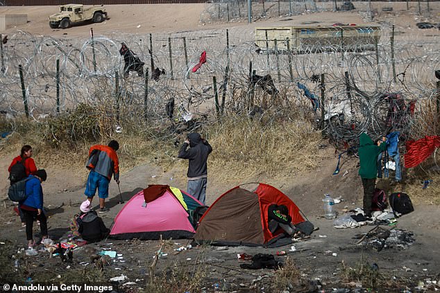 Migrants set up camp in the Rio Bravo, waiting to enter American Gate 36, as US soldiers cut off all access to the barbed wire fence in Ciudad Juarez, Mexico on January 2.