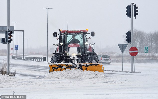 DENMARK: A man operates a snow plow in Aalborg, January 3