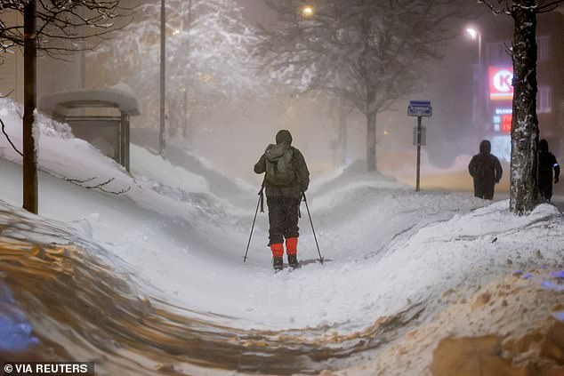 NORWAY: A person skis on the sidewalk after heavy snowfall in Kristiansand, January 3