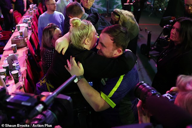 Littler hugs girlfriend Eloise Milburn, 21, after his win on Tuesday night.  She will be watching from the Ally Pally audience tonight