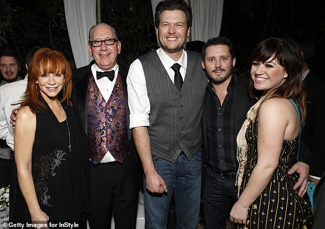 (L-R) Reba McEntire, president and CEO of Warner Music Nashville, John Espositio, Blake Shelton, Brandon and Kelly in 2012