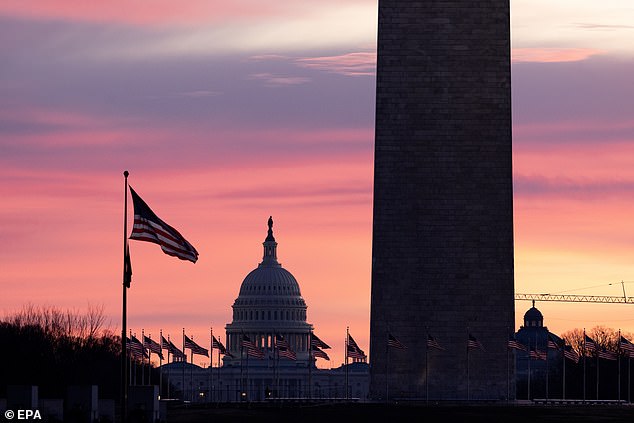 The United States Capitol can be seen behind the Washington Monument around sunrise