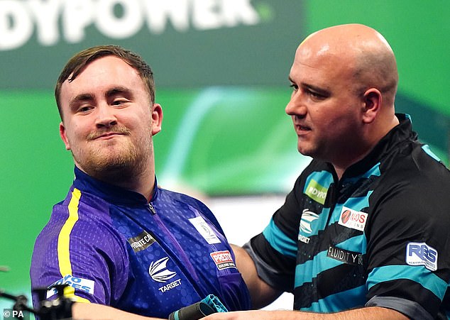 Littler can't help but smile as Rob Cross congratulates him on his semi-final win