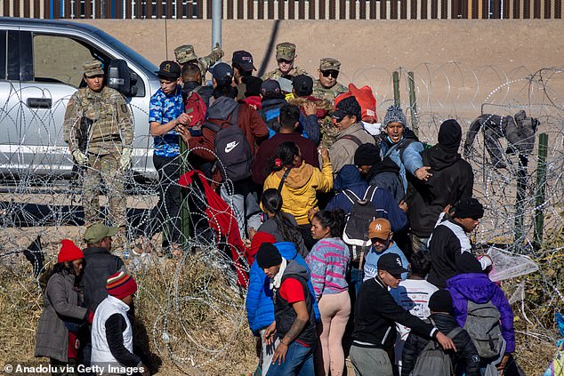 The Texas National Guard detains migrants crossing the Rio Grande River to seek humanitarian asylum before crossing the border into the United States in Ciudad Juarez, Mexico, on January 2, 2024.  Trump pointed to 250,000 crossing attempts in November