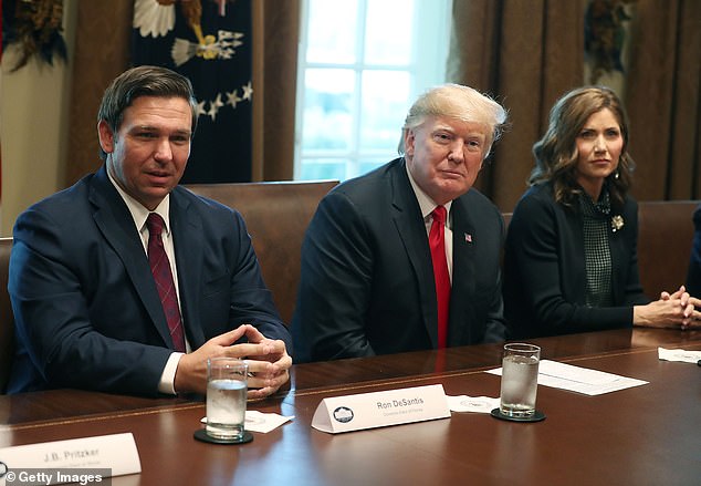 Pictured: Trump (center) flanked by Governor DeSantis and Governor Noem on December 13, 2018