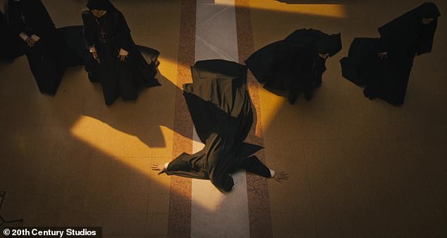 While playing in reverse, nuns are seen lying on the floor praying