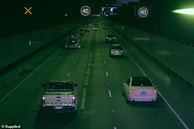 Mr Khan (pictured driving a white Audi sedan) said as soon as drivers passed the broken-down car in the left lane, they began to slowly accelerate.  However, for some reason the 40 hour speed limit was still enforced for some time after the lane blockage