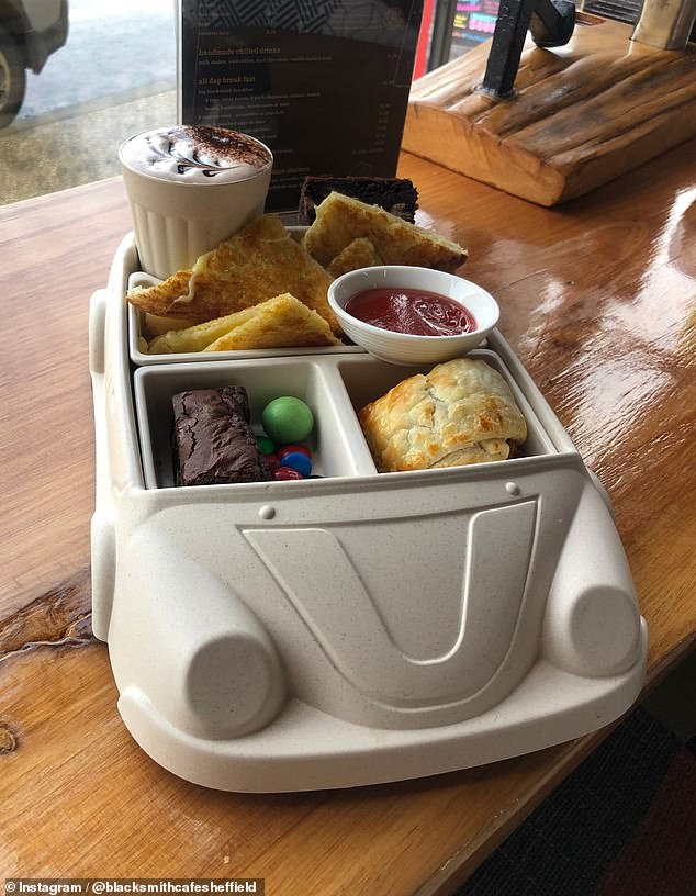 The 'I Don't Care' meal is prepared on a unique plate in the shape of a car, along with a drink of your choice.  In the car plate there is a sausage roll with sauce, a grilled cheese sandwich and a handful of sweets