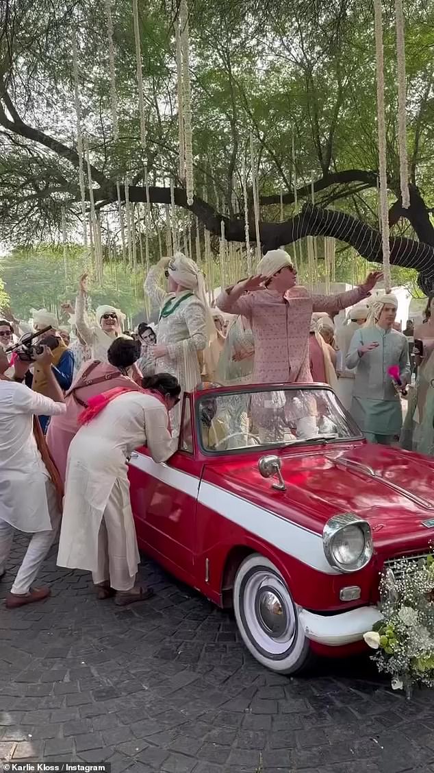 Family and friends were pictured enjoying the festivities in a vintage red and white car