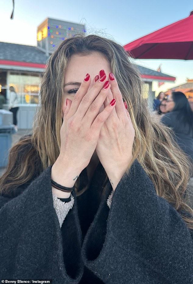 The images were taken outdoors, with the singer wearing a black wool coat as she posed with her red manicured hands near her face