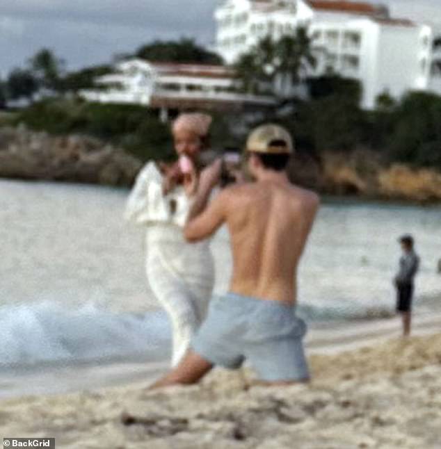 As Harry swam back to the yacht, Taylor appeared to be having a great time as she posed for photos taken by a friend