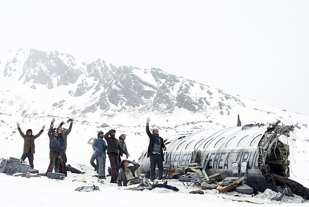 The film tells the harrowing story of a 1972 plane crash in the Andes Mountains, in which survivors had to resort to cannibalism as they tried to stay alive.  Pictured: A scene from the film detailing the survivors in the mountain