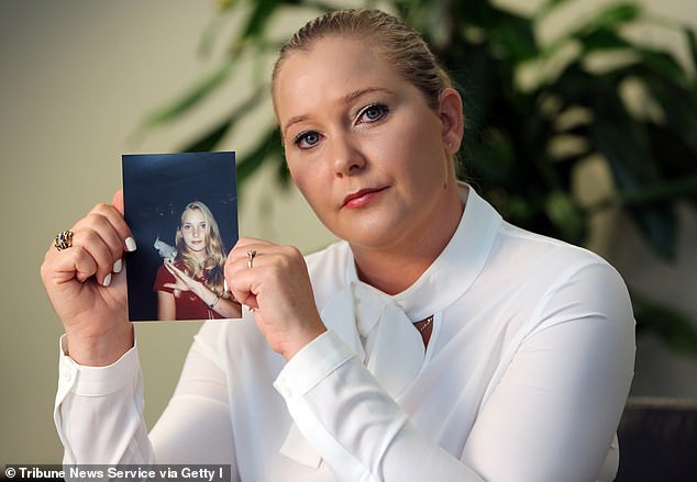 Virginia Roberts Giuffre holds a photo of herself at age 16 when she says Palm Beach multimillionaire Jeffrey Epstein began sexually abusing her