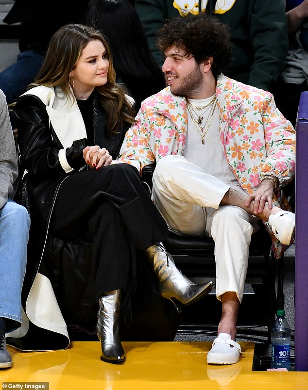 Selena modeled a black and white color-blocked trench coat, while her boyfriend donned a white jacket with a pink and orange floral print