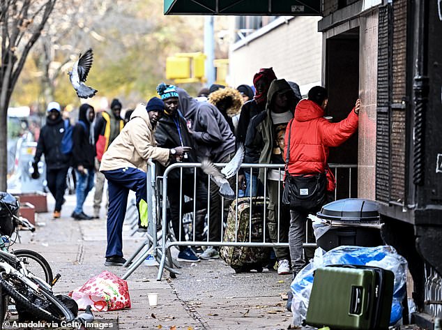 Asylum seekers line up for readmission in the East Village, which was converted into a city-run shelter for newly arrived migrant families on December 4