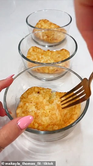 Thomas started by heating up three hash brown patties in her toaster.  When they were crispy, she put them in separate bowls and mashed them with a fork