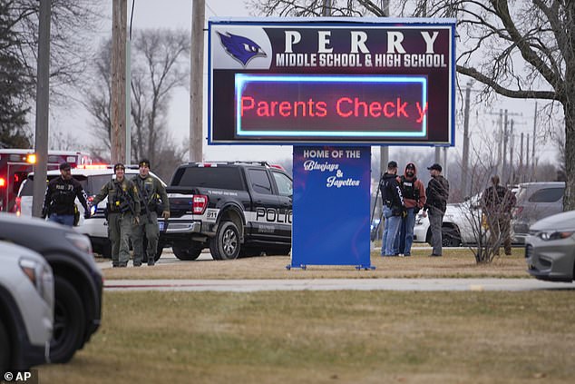 A sign is projected on site that informs parents what to do when they arrive at the school