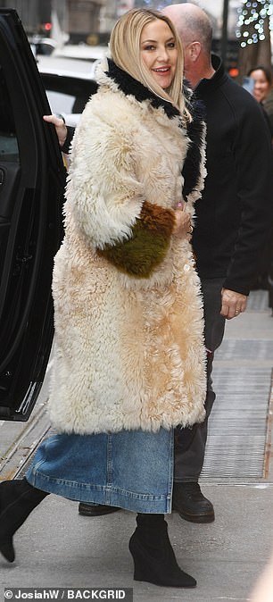 When she walked into Today, she had the coat on in full and was carrying a cute bag