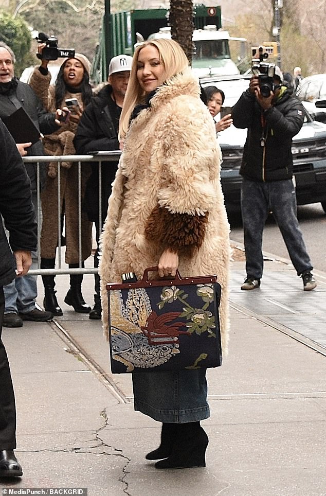 The bag was embroidered and had a wooden handle