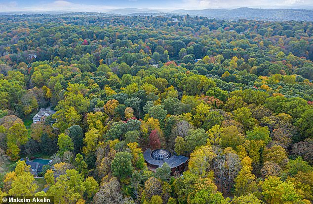 The property sits on 8.86 wooded acres in a quiet Westchester County hamlet, a short drive from Chappaqua's Main Street and a golf course.