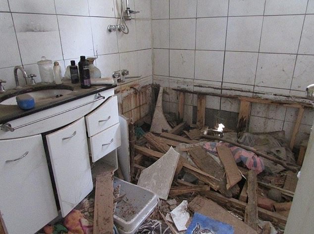 In the bathroom, the bathtub had also been ripped out of the ground and there was a hole in the wall where the drain pipe used to be (pictured), but the property sold in June for just $55,000