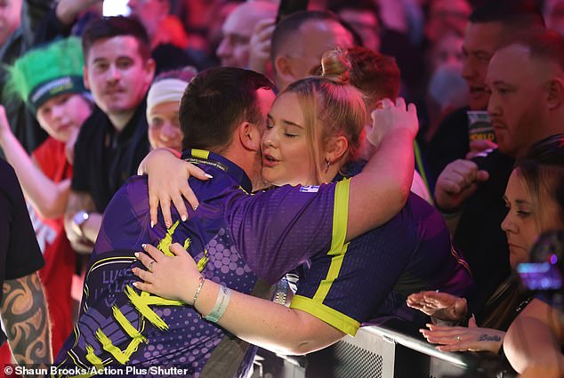 Littler hugs girlfriend Eloise Milburn before the finale.  Cruel online trolls are making fun of the age difference between the darts sensation and his partner, 21