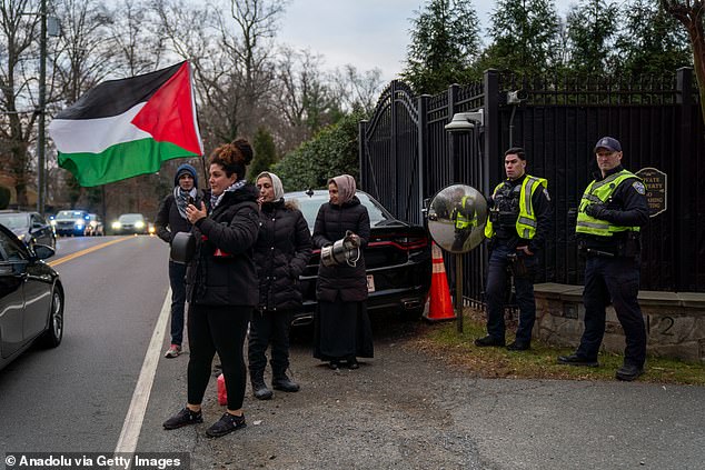 Officers standing outside his suburban Virginia home watched as he left for work