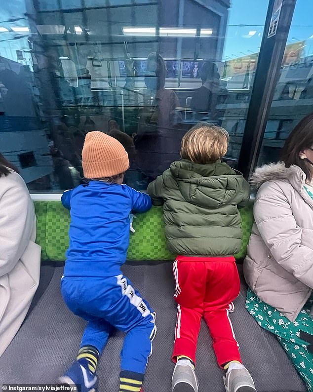 Sylvia also posted a photo of her two boys, Oscar, three, and Henry, two, who he shares with husband Peter Stefanovic (both seen here enjoying views of the Tokyo skyline)