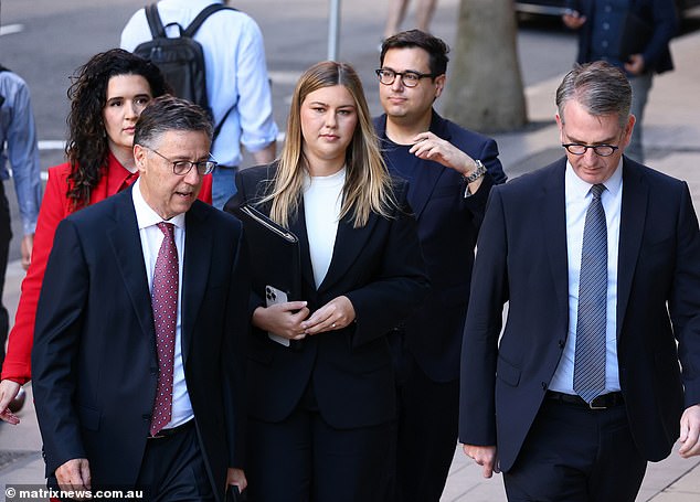 Lawyers argued that Brittany Higgins (pictured center) may have slept naked on the couch because she took off her dress before lying down to avoid throwing up on it and then passed out.