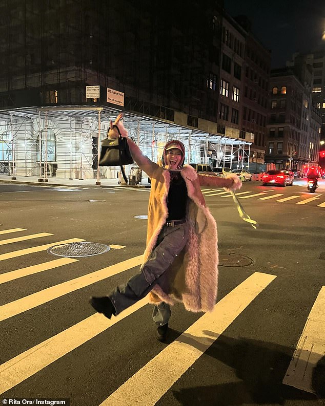 Other photos showed Rita throwing her hands in the air as she walked across a zebra crossing in a tan suede coat with sheepskin trim