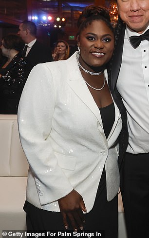 Danielle Brooks, 34, opted to move away from her red carpet look after wearing a white suit with nothing underneath as she hit the red carpet before slipping into a black dress with the same white blazer over it