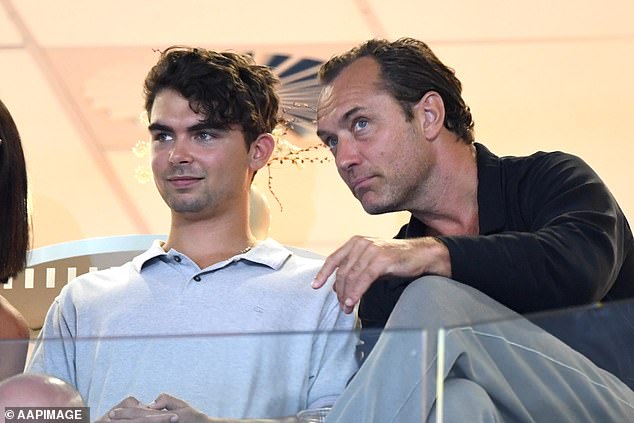 The 51-year-old British actor took part in a tennis match at the Brisbane International in Queensland alongside his son Rudy, 21 (left)