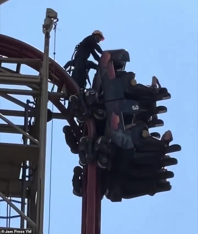 The ride went up a steep slope when it stopped, leaving riders in a near-vertical position (pictured)