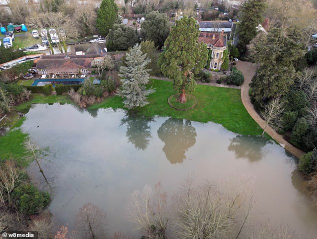 Their sprawling £12million Grade II listed building on the banks of the River Thames in Berkshire was seen surrounded by floodwaters, drone footage showed