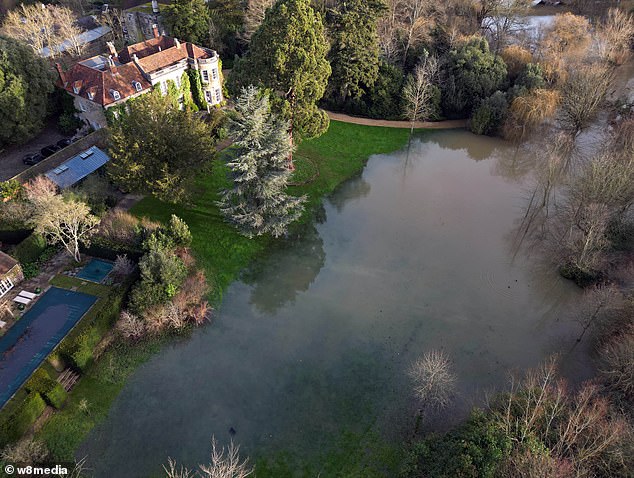 Pictures show the beautiful estate's manicured gardens flooded after weeks of heavy rainfall as the storm caused river levels to rise