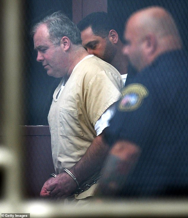 Skakel leaves Superior Court in handcuffs after the first day of his sentencing hearing on August 28, 2002 in Norwalk, Connecticut