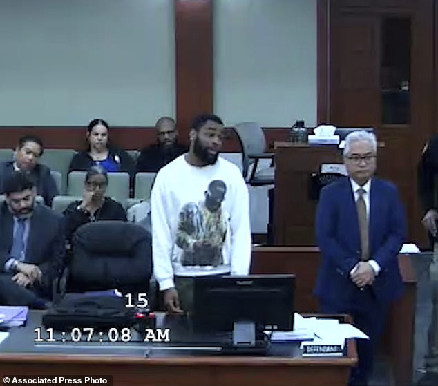 Defendant Deobra Redden wearing a white long-sleeved shirt is seen standing next to his attorney during his sentencing in a battery box, Wednesday, Jan. 3, 2024, in Las Vegas