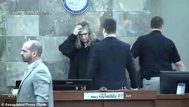 Judge Mary Kay Holthus is seen cradling her head after Redden jumped over her desk during his sentencing in a battery case, Wednesday, Jan. 3, 2024, in Las Vegas