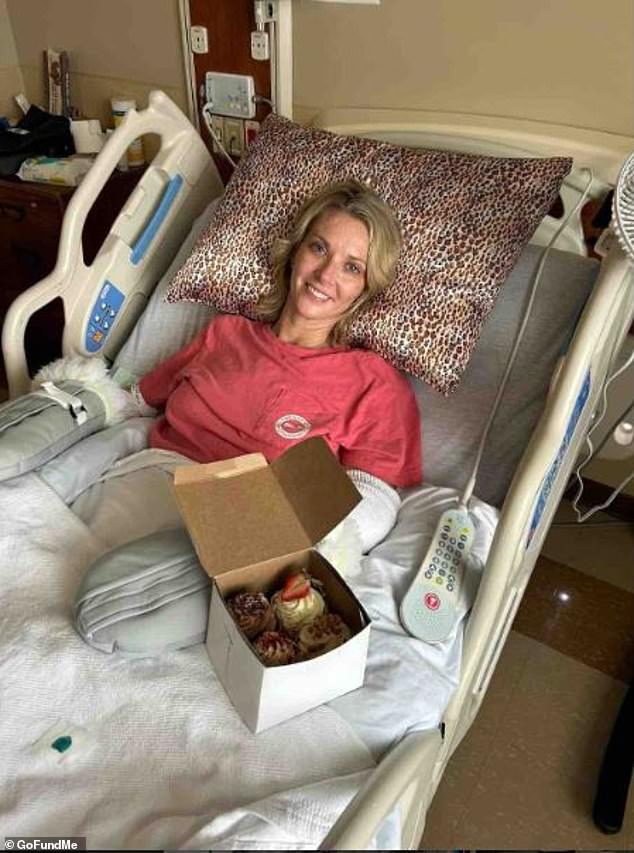 She was visited at the hospital by a friend who brought her a box of cupcakes and she posed next to them before getting into her wheelchair