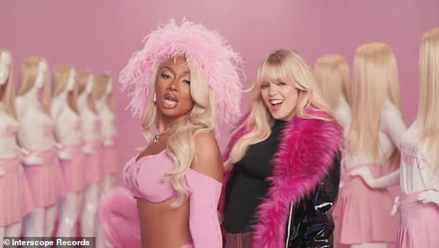 She stands next to Renee, who is wearing a patent leather jacket with fur lining, in front of an exhibition of Regina George mannequins