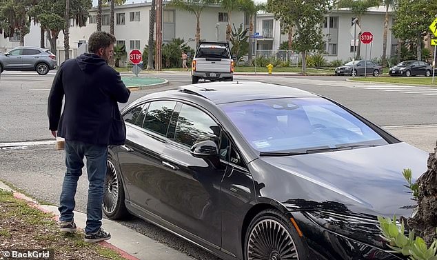 He opened his door for his wife, who was sitting in the passenger seat, and then closed the door firmly with a dramatic wave of his arm before walking to the driver's seat.