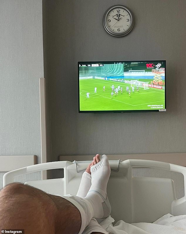 Showing his 1.1 million followers in his hospital room, James shared a photo of himself lying in bed watching football