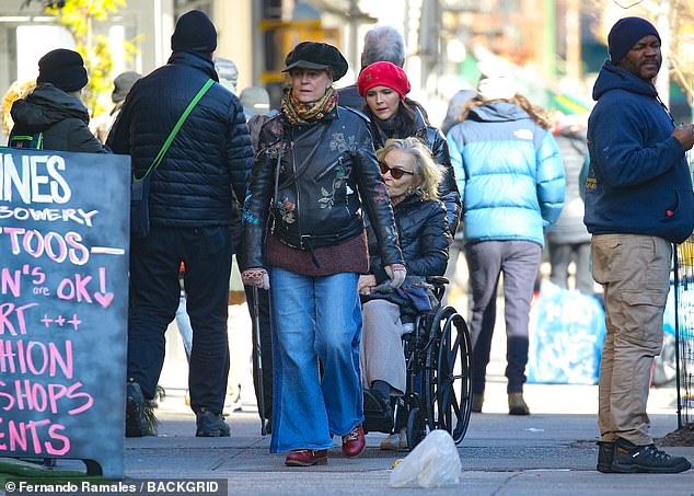 Sarandon, 77, walked comfortably next to her in jeans and a black motorcycle jacket with flowers on it