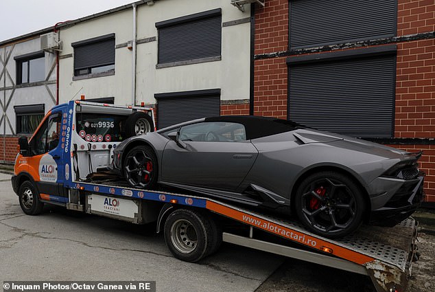 Romanian officials transport the seized sports cars to a secret storage location