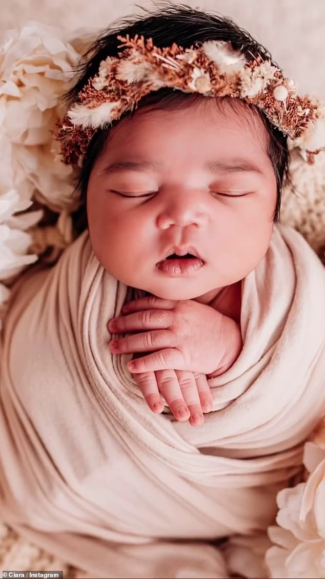 She was also placed in a basket surrounded by flowers, with an off-white wrap blanket and a woodland themed circle.