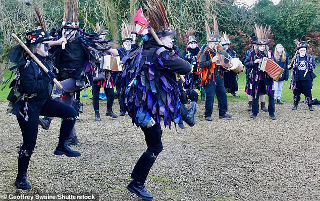 During the ceremony, the audience will be treated to a performance by Morris dancers, chants and traditional songs.  Pictured: Members of the Armaleggon Morris dancers at the Wassail ceremony in South Oxfordshire