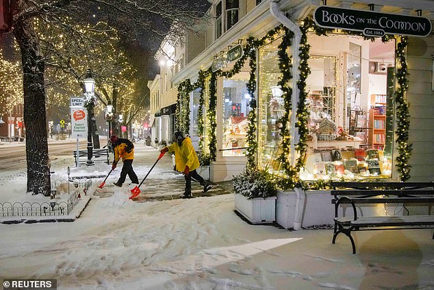 Workers clear sidewalks in Ridgefield, Connecticut, on Saturday.  In Connecticut, parts of Hartford County saw up to 9.5 inches of snow